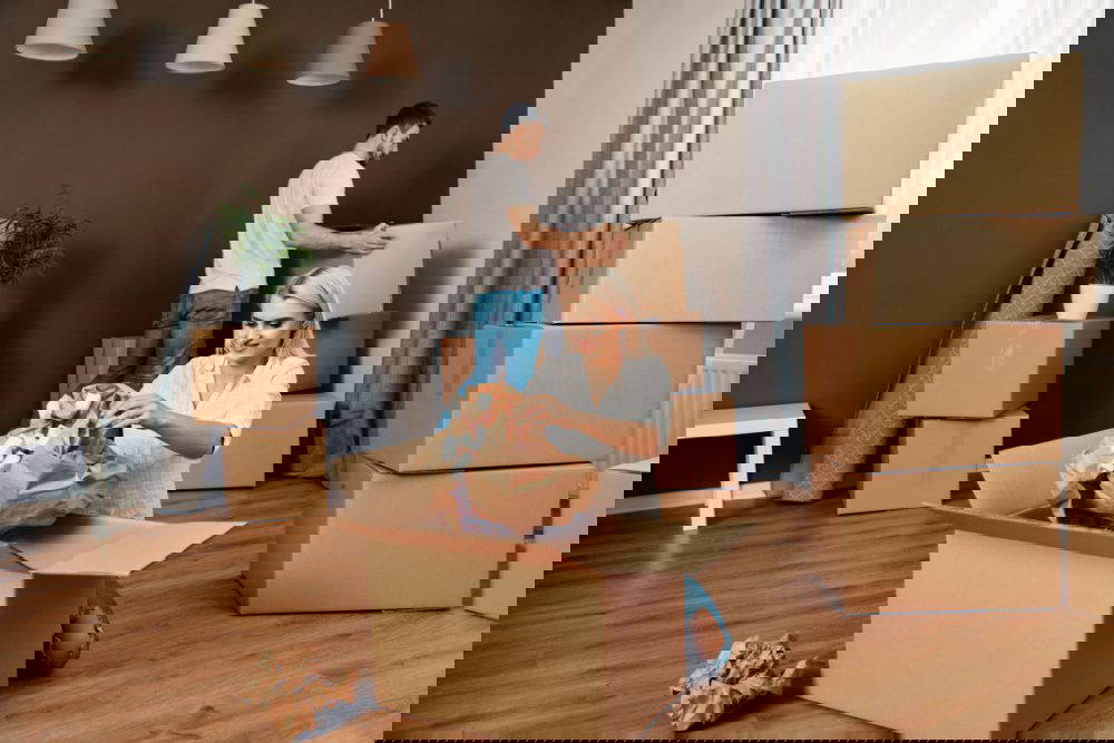 A couple unpacking boxes after moving home.